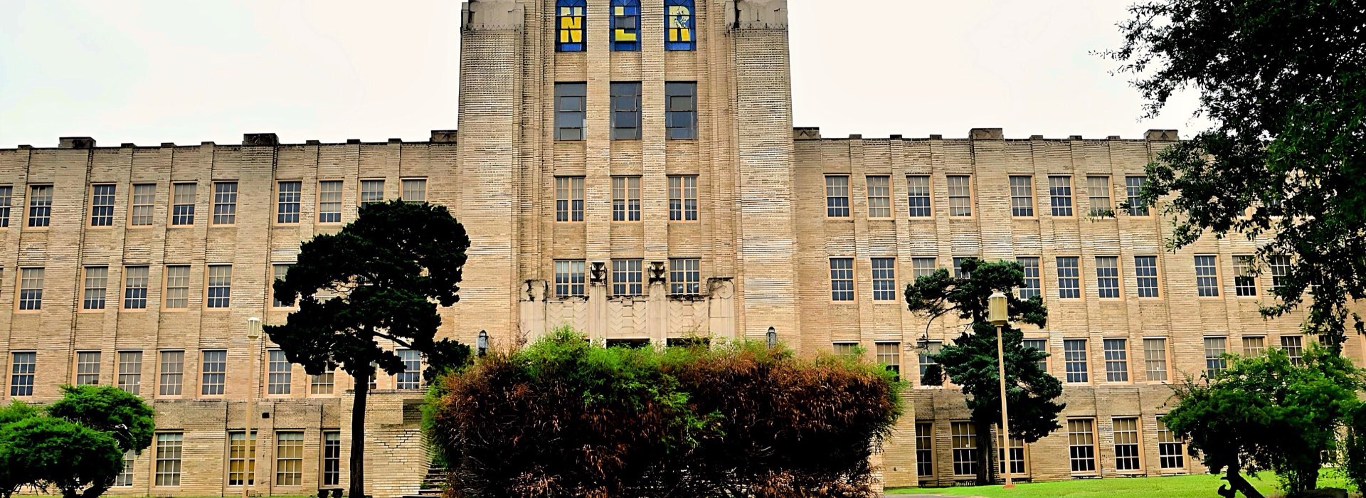 The facade of Ole Main, North Little Rock High School's historic 1929 building, with NLR spelled in the tower windows